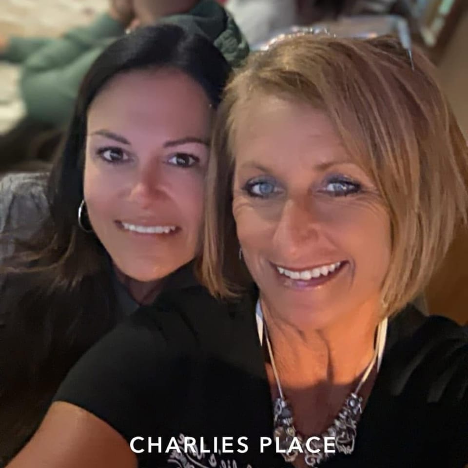 Two women smile for a selfie inside Charlie’s Place Restaurant & Lounge in Niantic, Connecticut.